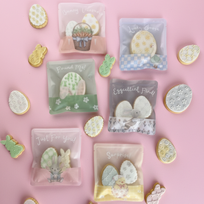 Decorative cookies with clear packaging on a pink background