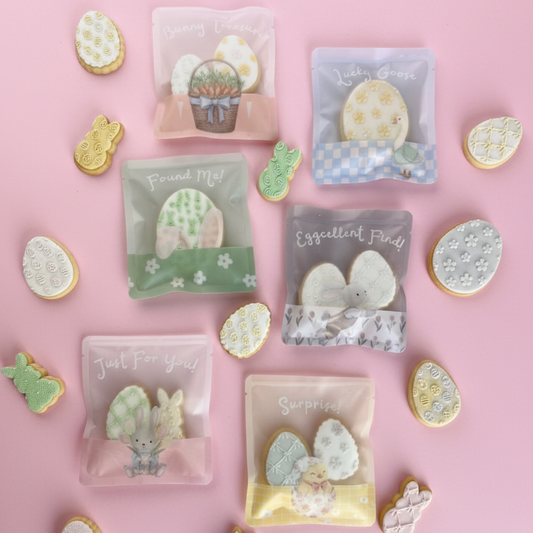 Decorative cookies with clear packaging on a pink background